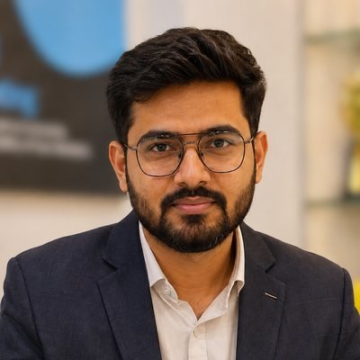 Rohan Sharma, in glasses and a navy blazer, photographed in the THECYBERHOST office